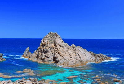 Blue seas surround a rocky island at Cape Naturaliste, Western Australia