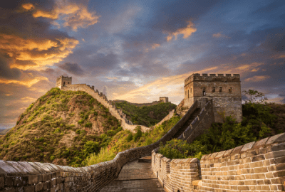 Looking along the Great Wall of China as it winds its way uphill at sunset