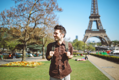 A man strolls by the Eiffel Tower