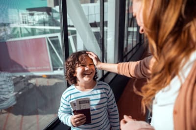 Mother and son waiting to board their plane