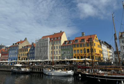 Ornate sailboats docked in front of the colourful buildings of Nyhavn docks