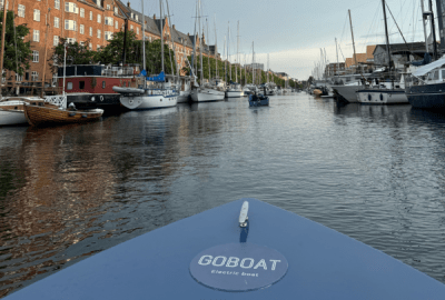 View over the bow of an electric boat in a canal in Copenhagen