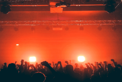 Red light bathes silhouetted revellers in a night club