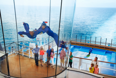 Two people indoor skydive high on deck