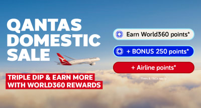 Qantas plane flying above clouds for a Qantas domestic sale with triple dip rewards on eligible flight bookings