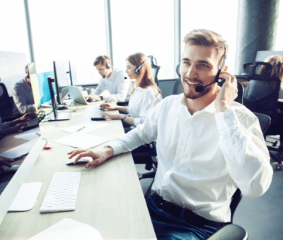A customer support Travel Manager with a headset talks to client