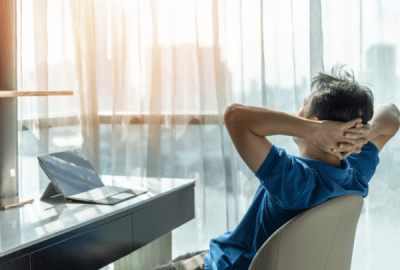 Businessman sitting in a chair relaxing in a hotel room