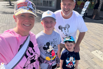 A family visiting Disneyland wearing Mickey Mouse T-shirts