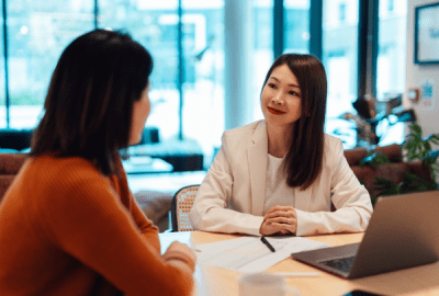A client facing conversation between two women in a business setting