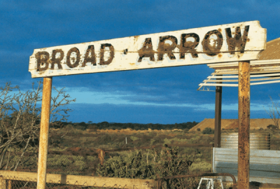 An old road sign reads "Broad Arrow" in weathered lettering