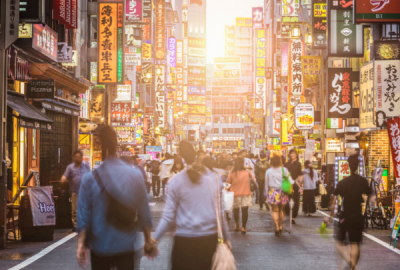Signs proliferate the skyline in Shinju, Tokyo at sunset.
