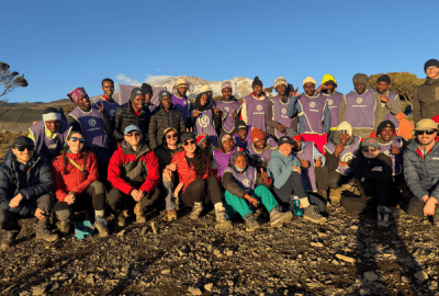 A hiking group and expedition staff gather for a photo