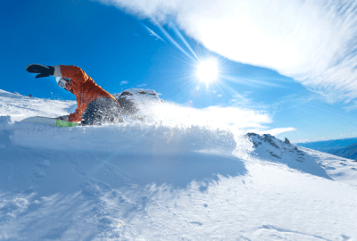 A snowboarder carves up the fresh snow of Cardrona ski field
