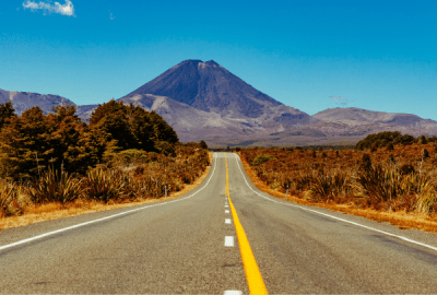 A view of Mount Ngrāuruhoe at the end of a straight road