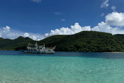 Crystal clear waters and a tour boat, Palawan Islands.