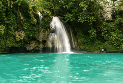 Kawasan Falls surrounded by lush forest and turquoise water