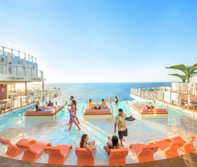 People relax by the pool on a cruise ship deck with ocean views