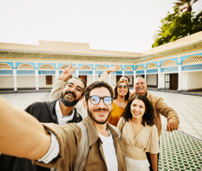A family smiles while taking a selfie