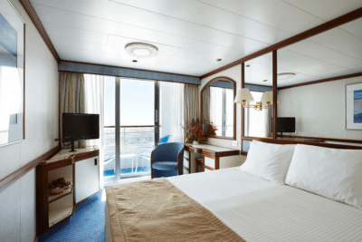 Looking out to sea from the interior of a stateroom on a cruise ship