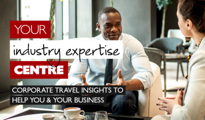 Your industry expertise centre - corporate travel insights to help you & your business. Black businessman and white businesswoman having a meeting over coffee