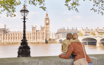 Woman and young boy hugging while looking across the River Thames at Big Ben in London