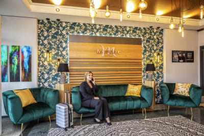 A person talks on the phone in the foyer of a Mercure hotel