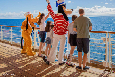 Goofy, Pluto and friends wave to the distant horizon aboard a Disney Cruise line vessel