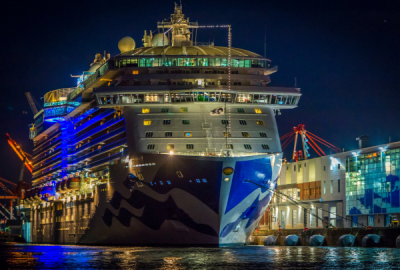 A cruise liner moored at night in electric blue light