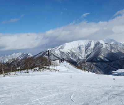 A snow-covered ski slope on a sunny day