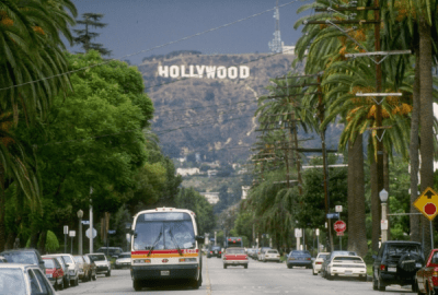 Street view of Hollywood with the iconic hill sign in the background
