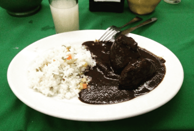 A Mexican meal served with mole sauce.