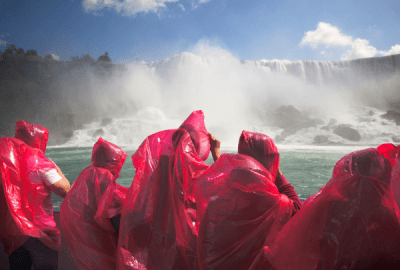 The Niagara Falls sprays tourists in a viewing boat