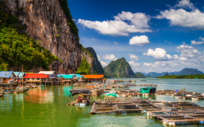 Boats surrounded by vertical cliffs in Phang Nga town, Thailand.