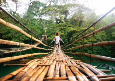 Woman walking along a bridge in the Philippines