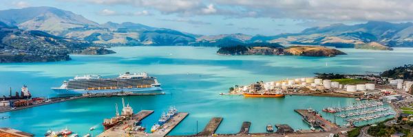 Cruise ship docked at Christchurch marina with mountainous background