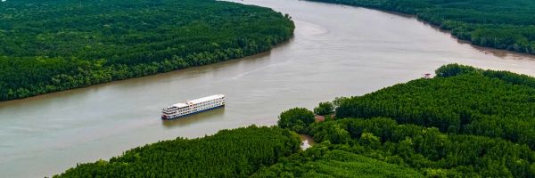 Drone shot of river ship cruising down the Mekong River