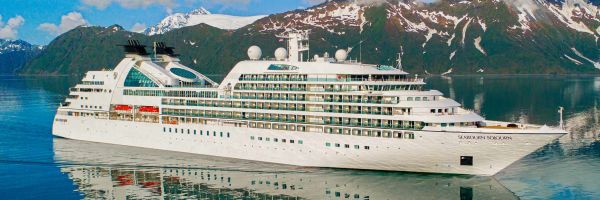 Cruise ship with snow-capped mountains in background