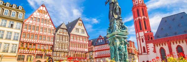 Romerberg city square in Frankfurt - brightly coloured Bavarian buildings and a statue of justice