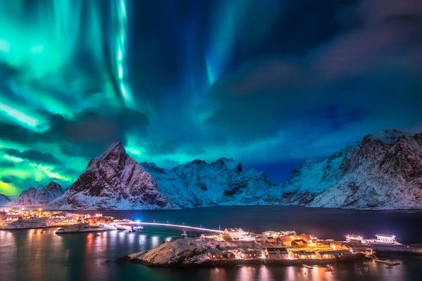 Northern Lights above snow-capped mountains