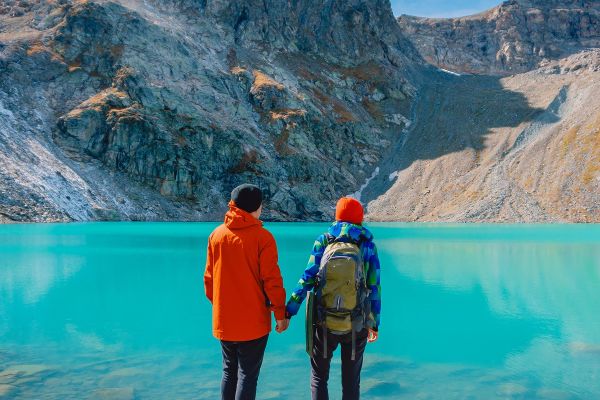 Holding in hands in front of lake