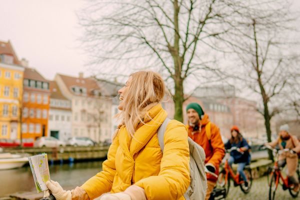 People riding bikes through a city in Northern Europe
