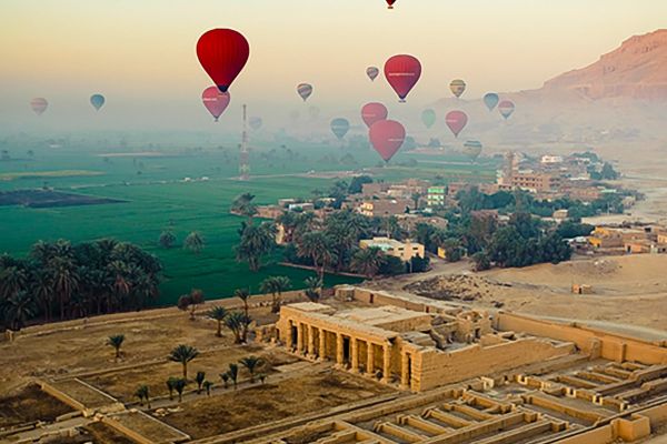 Hot air balloons flying over ruins in Egypt