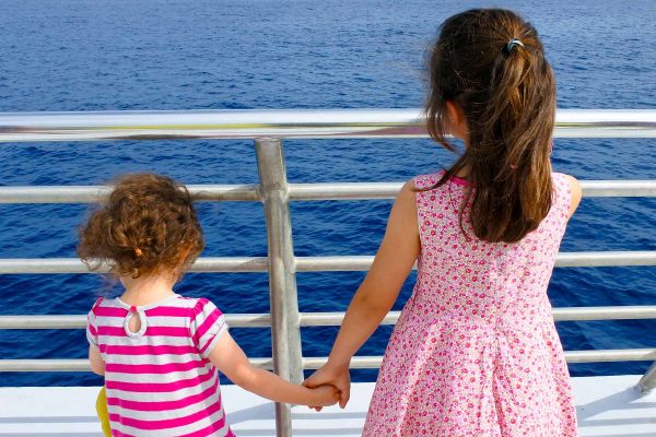 Two girls overlooking cruise balcony