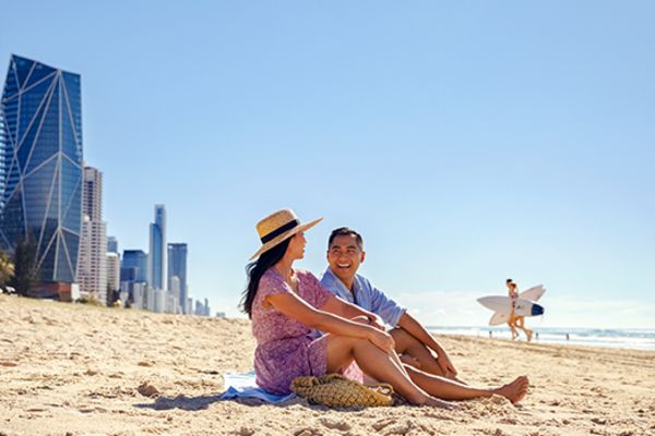 Couple sitting on the beach on the Gold Coast