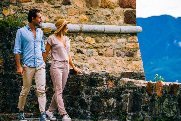 Couple walking hand in hand along a brick path