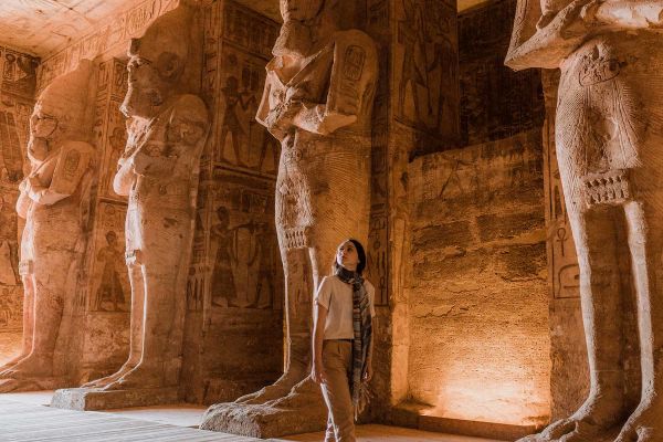 Lady admiring statues carved out of sand