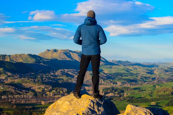 Man standing on rock overlooking mountainous range