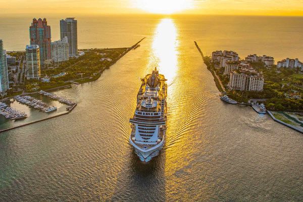 Drone shot of cruise ship with sunset in background