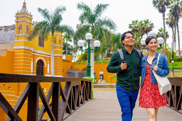 Happy young Latin couple taking a walk on Puente de los Suspiros, Barranco, Lima, Peru