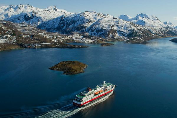Cruise ship travelling through to mountain ranges